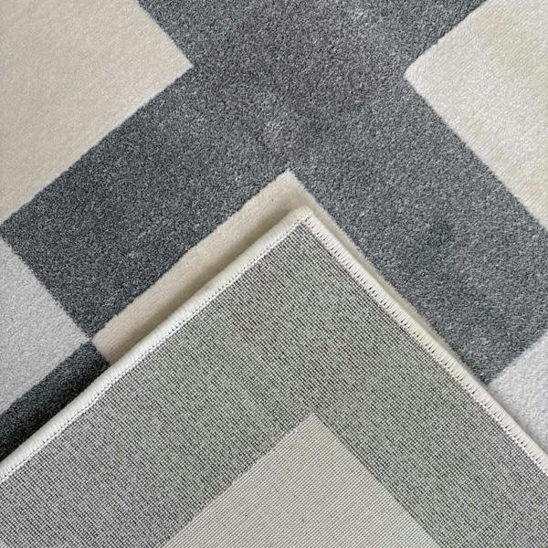 Gray and beige checkered patterned rug