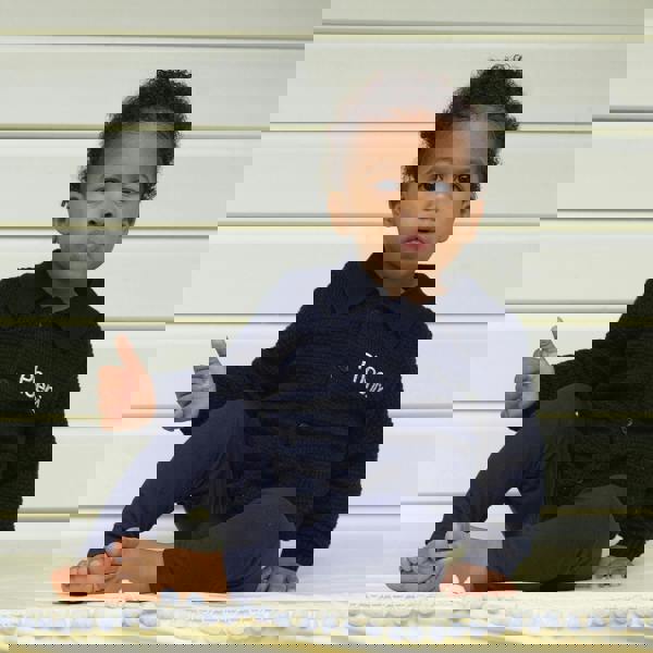 Baby boy wearing navy moss stitch cardigan, styled with navy knitted trousers.