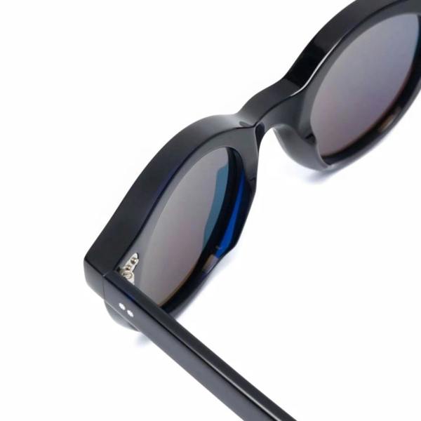 Cutler & Gross 1390 round sunglasses in black on blue