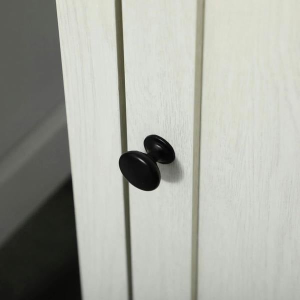 White cabinet door panel with round black knob handle