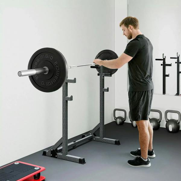 Adjustable squat rack holding a barbell across J-hooks, with weight plates on both ends