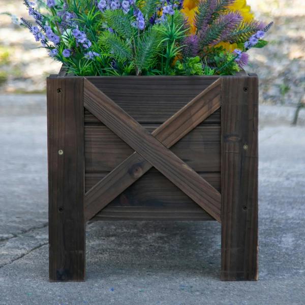 Dark brown wooden raised planter bed with X cross-brace panels and slatted interior