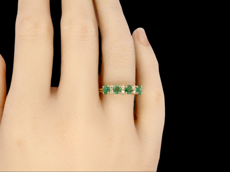 An Emerald and Diamond Ring finger view