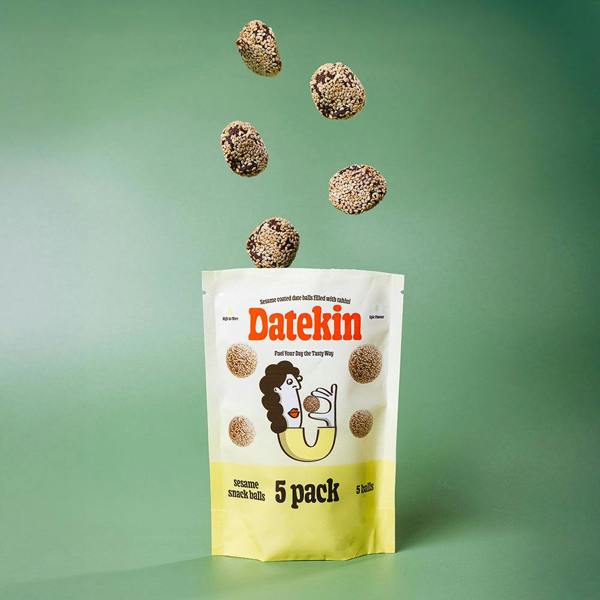 Datekin sesame snack balls packaging with sesame date balls levitating above on a green background