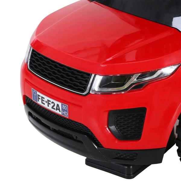 Close-up of red front bumper and grille on a toddler ride-on car with LED-style headlights