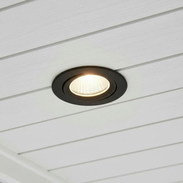 black outside downlight mounted into a white soffit of a home