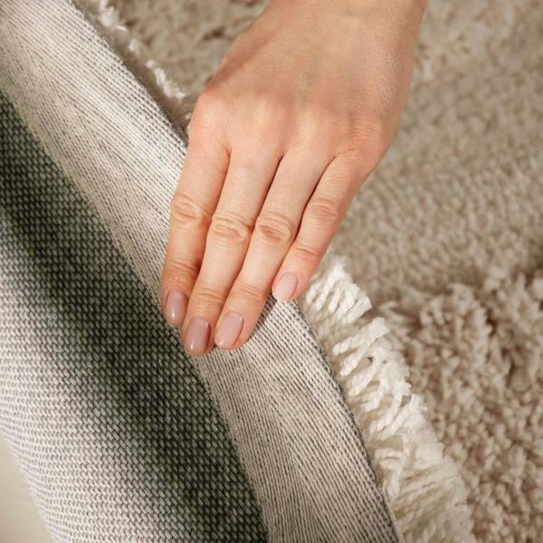 Hand touching a textured fabric surface