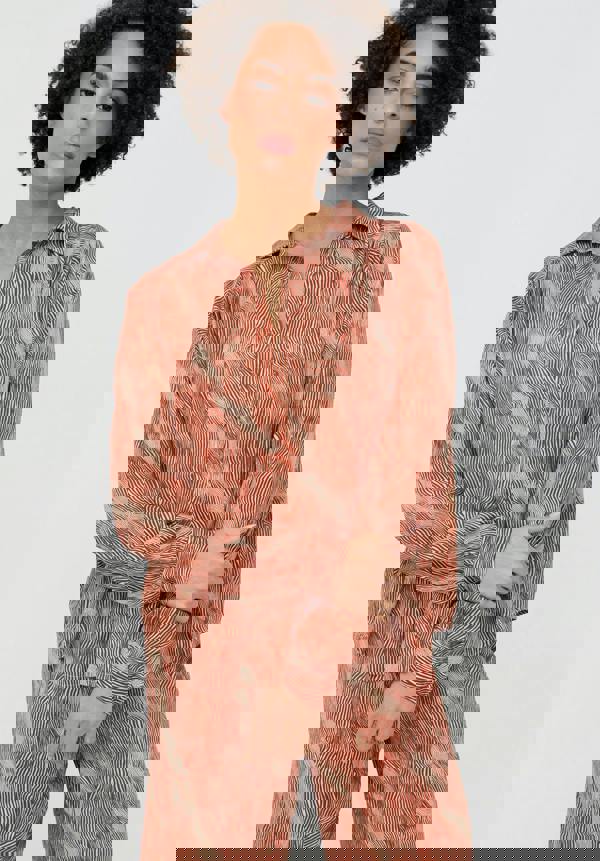 Woman wearing a red and white patterned outfit on a white background