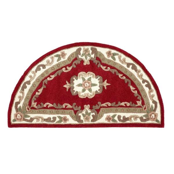 Decorative half-moon rug with red and beige pattern on a white background