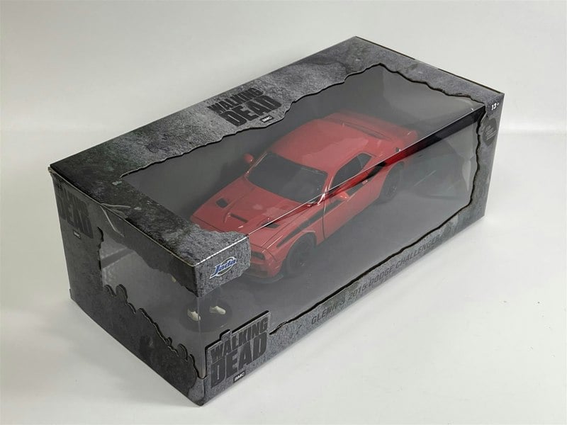 a red toy car in a box