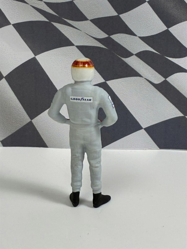 a toy figure of a man in a race suit