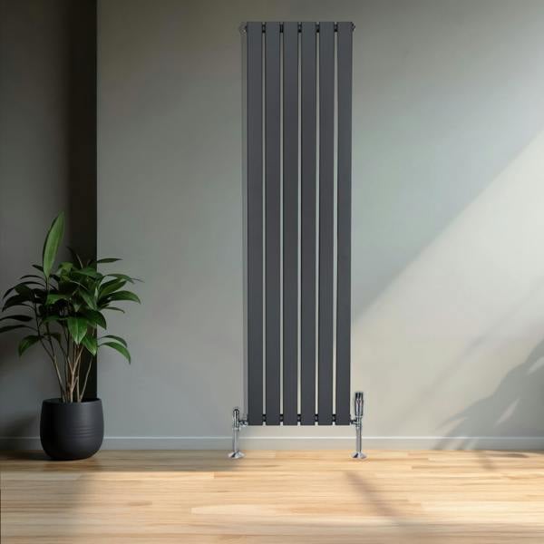 Flat single column radiator in anthracite grey, featuring sleek vertical lines and chrome feet, set against a minimalist interior with a plant