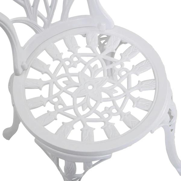 White ornate chair back with circular cutout design and small central detail