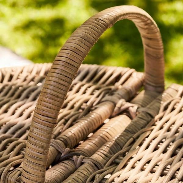 Sturdy rattan handle and lid hinge detail on a picnic basket.
