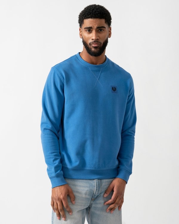 model wearing a Belstaff Mens Crew Neck Sweatshirt With Logo Patch in Marine Blue