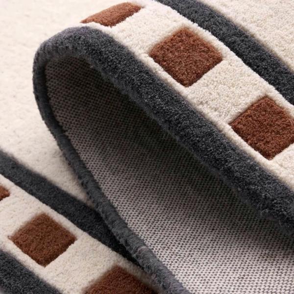 Close-up of a textured rug with geometric pattern on a light background