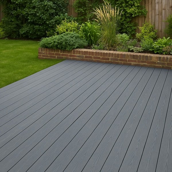Grey composite decking boards arranged neatly in a spacious garden, showcasing a smooth texture and durable finish against lush greenery