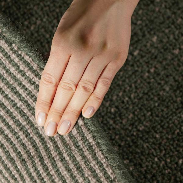Close-up of a hand on a textured fabric surface