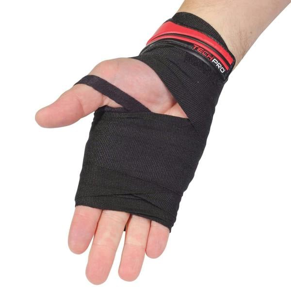 Hand wearing black Optimum Tech Pro boxing wrap with red trim, palm view on white - Optimum