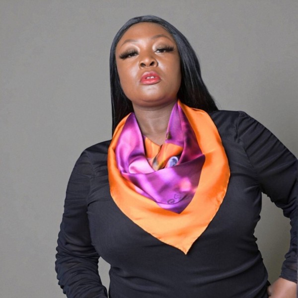 Silk scarf with Orange Bird of Paradise and Pink and Purple print, styled elegantly around model's neck over a Black Plus Size Bodycon Dress.