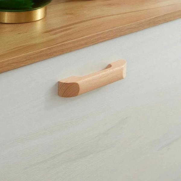 Light wood handle on cream white shoe cabinet drawer front
