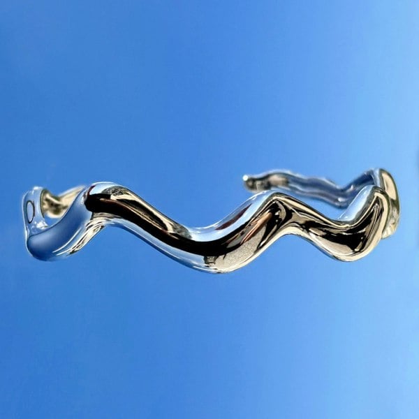 Ocean-inspired silver cuff bracelet by LENAE London, featuring wavy curves.