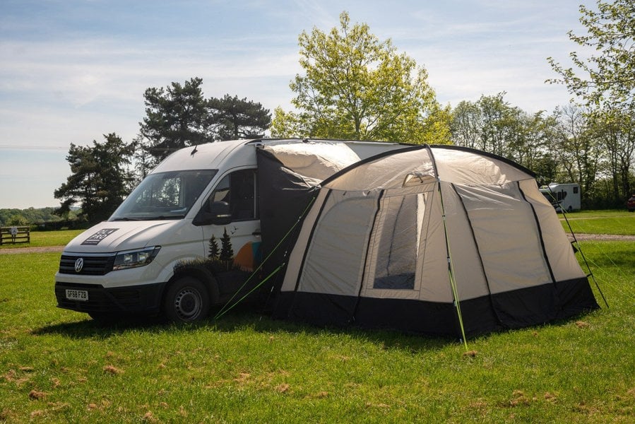 An image of the Cubo XL Motorhome Awning - Fibreglass Poles from OLPRO that is attached to a VW Crafter.