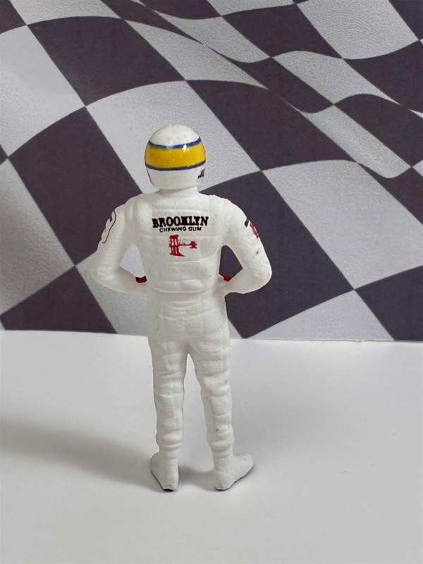 a toy figure of a man in a white helmet