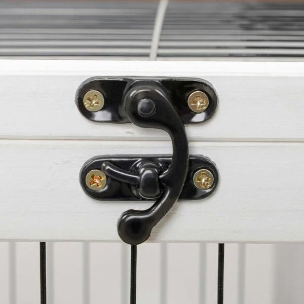 Black metal latch for white wooden pet hutch door with screw fasteners