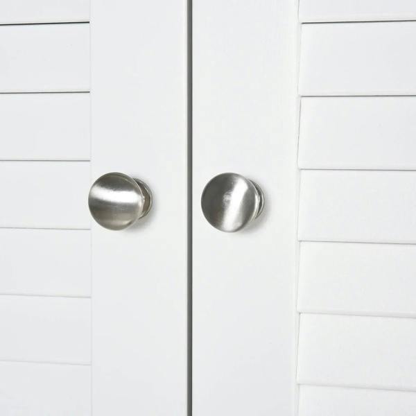 Close-up of silver round knobs on white shutter cabinet doors