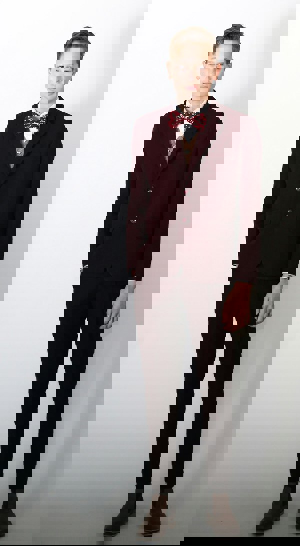 Young boy wearing beautiful burgundy suit