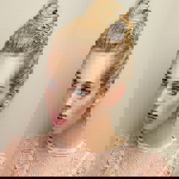 rose gold hair clip claw in blue with bun hairstyle