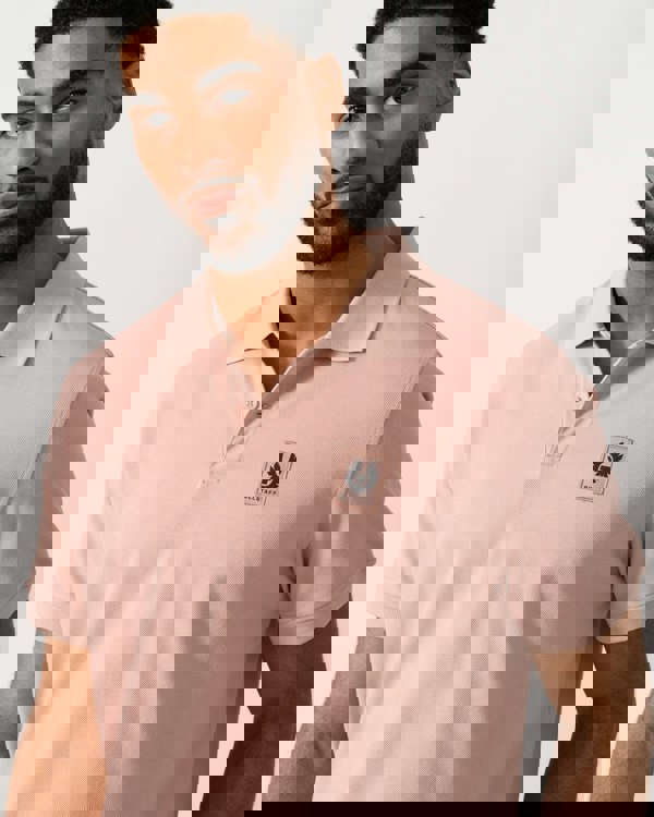 detail shot of a Model wearing a Belstaff Short Sleeved Mens Polo in Dusk Pink