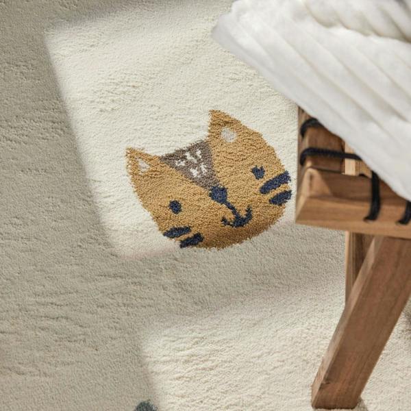Textured white rug with a fox design next to a wooden stool
