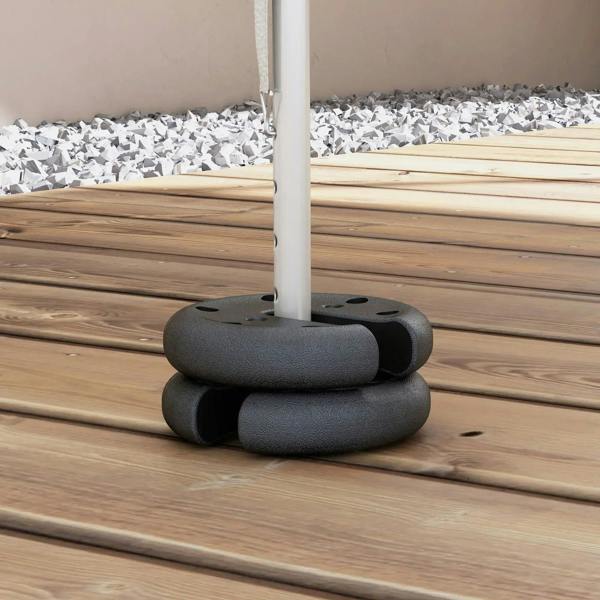 Dark gray tent leg weight securing a pole on wooden boards