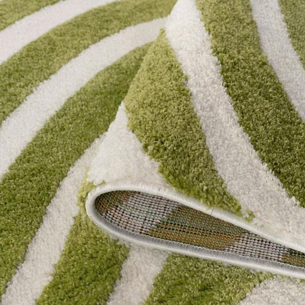 Green and white striped rug with a corner being pulled away