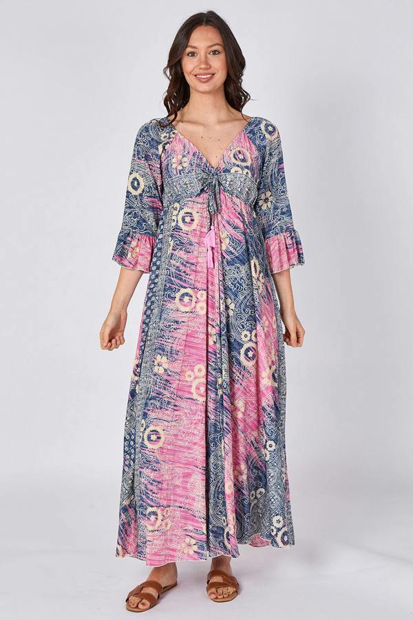 Woman wearing a long, patterned dress on a white background