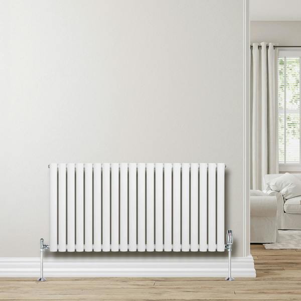 Sleek white oval single column radiator, 600 x 1200mm, mounted on a light wall, complementing a modern interior with wooden flooring