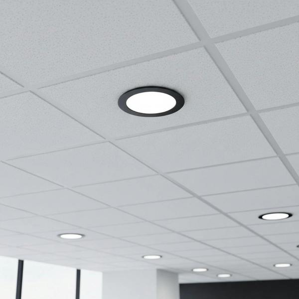 black low profile downlight installed into a suspended ceiling in an office