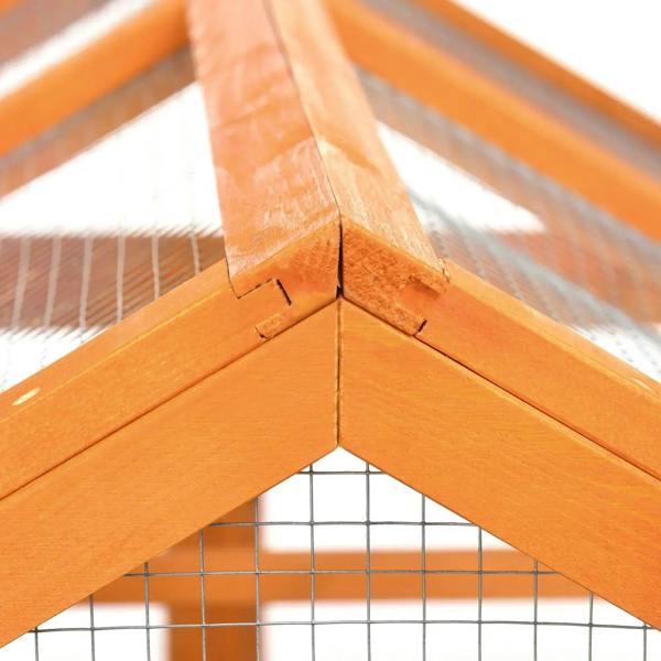 Close-up of orange corner joint on wooden wire-mesh chicken run roof frame