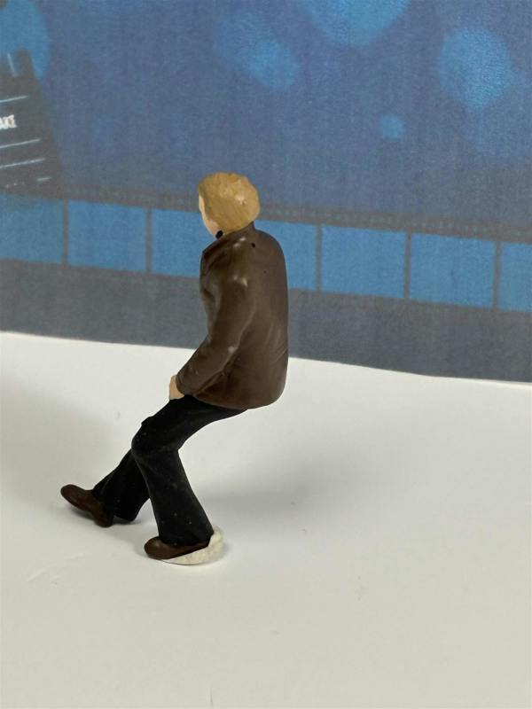 a small toy figure of a man walking