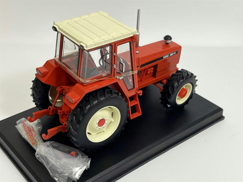 a red tractor on a black stand