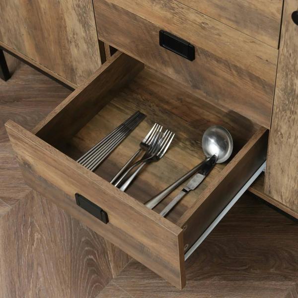 Rustic brown sideboard drawer open with cutlery organizer and black pull handle