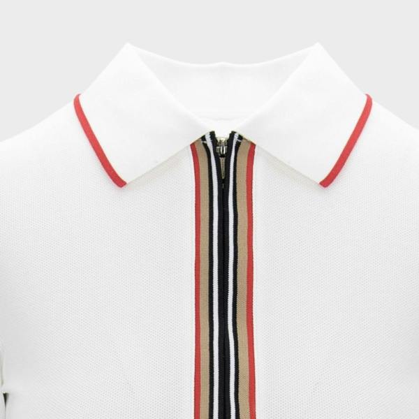 Supplied Fashion white polo dress featuring a zip-front closure with red, black, and beige striped trim detail.