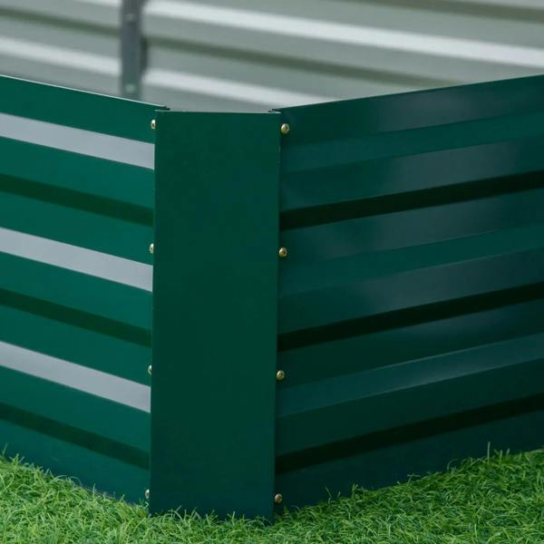 Green metal raised garden bed end panel with bolts, set on green grass