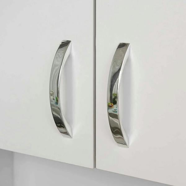 Chrome curved handles on white cabinet doors, close-up