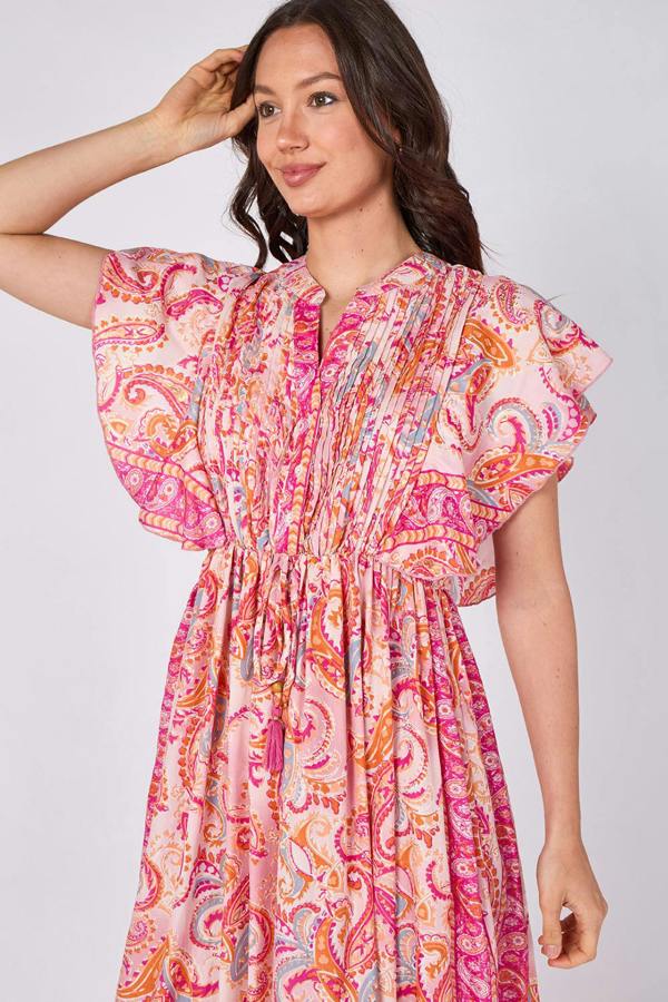 Woman wearing a colorful patterned dress on a white background