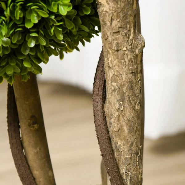 Artificial boxwood topiary tree trunk close-up with textured bark and green ball foliage