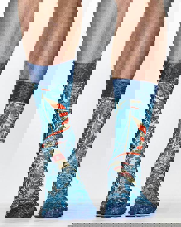 Blue socks with maritime design worn by a person on a white background