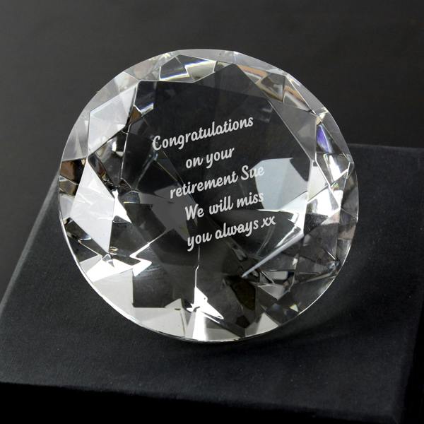Custom engraved crystal diamond paperweight resting in a black silk lined gift box reading Happy Retirement On your next adventure.